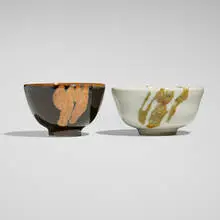 Tea bowls, set of two by Brother Thomas Bezanson, c. 2003, crystalline rutile-glazed porcelain, ice crackle with iron yellow-glazed porcelain, sold Nov 2025
