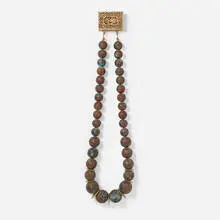 Clasp for William by Margaret Wharton, 1989, carved wood, patinated copper sheet, sold May 2025