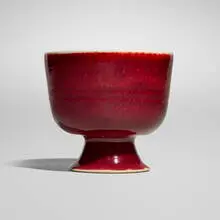Footed bowl by Brother Thomas Bezanson, c. 1984, copper red-glazed porcelain, sold Aug 2025
