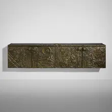Paul Evans, Sculpted Bronze wall-mounted cabinet, 1973, bronzed resin over wood, enameled steel, slate, lacquered wood