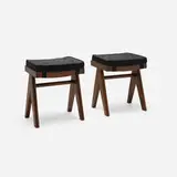 Low stools from the M.L.A. Flats building, Chandigarh, pair by Pierre Jeanneret, c. 1955-56, teak, upholstery, cane, sold Feb 2026