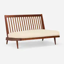 Settee by George Nakashima, 1958, American black walnut, canvas upholstery, sold May 2025