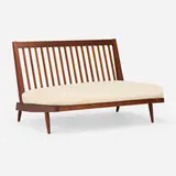 Settee by George Nakashima, 1958, American black walnut, canvas upholstery, sold May 2025