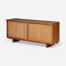 Sliding Door cabinet by George Nakashima, 1974, American black walnut, pandanus cloth, oak, sold May 2025