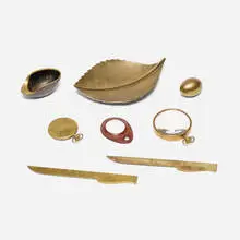 Collection of eight tabletop accessories by Carl Auböck, 1937-1958, brass, glass, leather, sold Jan 2026