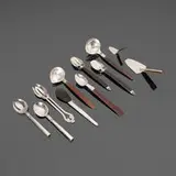 William Philip Spratling, Collection of nine serving articles, c. 1940-1967, sterling silver, ebony, rosewood, silver