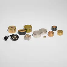 Dale Chase, Collection of ten boxes, c. 1995, garnet, cold enamel, gold plating, sterling silver, metal, African blackwood, cord