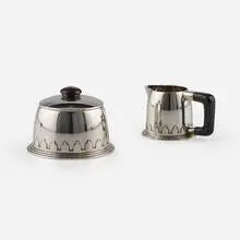 Jean E Puiforcat, Covered sugar bowl and creamer, c. 1930, sterling silver, Bakelite