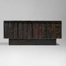 Deep Relief cabinet, model PE-42 by Paul Evans, c. 1970, torch-cut, welded, polychromed and patinated steel, enameled wood, cleft slate, sold Jan 2025