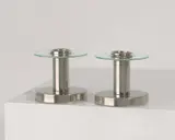 Naum Slutzky, A Paar Kerzenständer, Um 1930, Neusilber, vernickelt, mattiert; Glas. 6,5 cm; Ø 7,5 cm (2 ½ in.; Ø 3 in.)