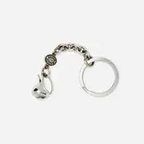 Henning Koppel for Georg Jensen, Pregnant Duck keyring, 2000-2008, sterling silver, stainless steel, offset lithograph, bound printed paper