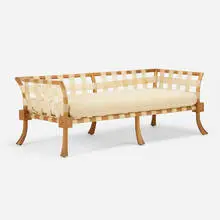 Rare settee by T. H. Robsjohn-Gibbings, c. 1940, bleached walnut, vellum, upholstery, sold May 2024