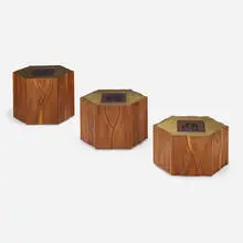 Custom occasional tables, set of three by Phillip Lloyd Powell, 1976, carved and sculpted walnut, gold and silver leaf over painted wood, found carved rosewood panels, glass, casters, sold May 2024