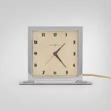Gilbert Rohde, Table clock, c. 1935, chrome-plated aluminum and steel, glass, enameled aluminum