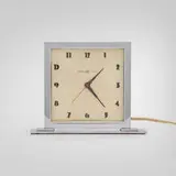 Gilbert Rohde, Table clock, c. 1935, chrome-plated aluminum and steel, glass, enameled aluminum