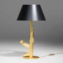 Prototype Golden Gun table lamp by Philippe Starck, 2005, gold leaf over aluminum, paper shade, sold Nov 2025