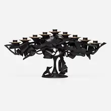 Menorah by Albert Paley, 2013, forged mild steel with a blackened patina, removable brass bobeches (collars), sold May 2023