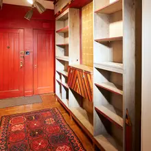 Bookcase by Phillip Lloyd Powell, c. 1975, walnut, rosewood, zebrawood, painted wood, gold leaf, patinated metal, sold May 2023