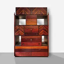 Cabinet by Phillip Lloyd Powell, c. 1990, walnut, ash, cocobolo, ebony, painted wood, gilt metal, mirrored glass, sold May 2023