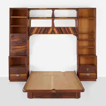 Queen bedframe and surround by Phillip Lloyd Powell, c. 1990, walnut, ash, cocobolo, ebony, painted wood, mirrored glass, patinated metal, bone inlay, sold May 2023
