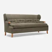 Canett Wingback sofa by Tyler Hays, c. 2020, bouclé upholstery, cherry, sold Oct 2025