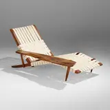 Long Chair with Right Arm by George Nakashima, 1972, American black walnut, webbing, suede upholstery, sold May 2023