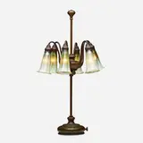 Six-light Blossom table lamp by Tiffany Studios, c. 1910, patinated bronze, hand-blown Favrile glass, sold May 2023