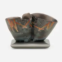 Pair on Base No. 807 by Bennett Bean, 2000, pit-fired, painted, and black-leafed earthenware, enameled MDF base, sold Jan 2023