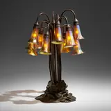 Twelve-light Lily table lamp by Tiffany Studios, c. 1910, patinated bronze, hand-blown Favrile glass, sold Jan 2023