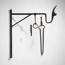 Wall-mounted kettle hook and fire tongs from the Walter Mellor House, Mount Airy, PA by attribution Samuel Yellin, c. 1925, wrought iron, sold Jan 2023