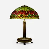 Poinsettia table lamp by Tiffany Studios, c. 1910, leaded glass, patinated bronze, sold Jan 2023