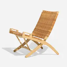Folding chair by Hans J. Wegner, 1949 / 2000, birch, cane, brass, sold Jul 2025