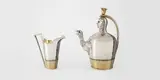 Teekanne und Sahnegießer im ägyptisierenden Stil by Johann George Fournier II, Um 1800, Silber, gegossen, getrieben, zieseliert, vergoldet, montiert, sold Nov 2012