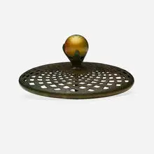 Ball heat cap by Tiffany Studios, c. 1910, patinated bronze, Favrile glass, sold Sep 2022