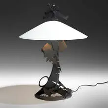 Dragon's Back table lamp by Albert Paley, 1999, formed and fabricated steel with a monochromed-charcoal gray finish, frosted glass, sold May 2022