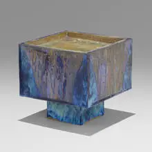 Cube with recessed top and square base by Otto Natzler, 1980, earthenware with Blue Reduction Fired glaze, melt-fissures, iridescence, and glass pool, sold May 2022