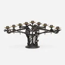 Menorah by Albert Paley, 1999, forged and fabricated steel with a blackened patina, removable brass bobeches (collars), sold Jan 2022