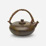 Teapot by Toshiko Takaezu, c. 1965, glazed earthenware, twigs, cord, leather, wire, sold Sep 2021