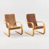 Alvar Aalto, A pair of model 406 armchairs, birch with wowen fabric