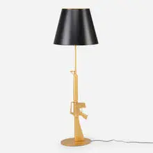 Lounge Gun floor lamp by Philippe Starck, 2005, gilt aluminum with polymer coating, gilt steel, sold Mar 2025