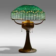 Vine Border table lamp by Tiffany Studios, c. 1910, leaded glass, patinated bronze, sold Sep 2021