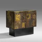 Patchwork bar cabinet by Paul Evans, c. 1970, welded and enameled steel, copper, and brass, slate, casters, sold May 2021