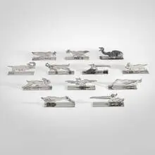 Paul Dehalle, Animalier figural knife rests, set of twelve, c. 1930, silver-plated metal