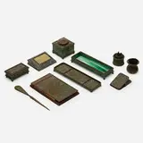 Collection of ten desk articles by Tiffany Studios, c. 1910, patinated bronze, Favrile glass, wood, paper, plastic, horse hair, sold May 2021