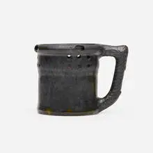 Puzzle mug by George E. Ohr, 1898-1910, glazed earthenware, sold May 2021