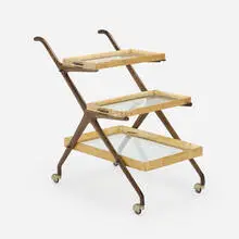 Three-tier bar cart by Aldo Tura, c. 1955, walnut, vellum, glass, brass, sold Jan 2025