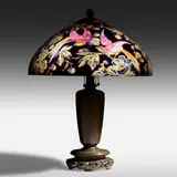 Table lamp with birds of paradise by Handel, c. 1920, reverse painted and acid-etched glass, patinated metal, sold Jan 2021
