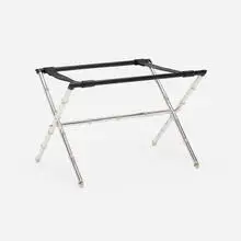 Luggage stand by Jacques Adnet, c. 1950, chrome-plated brass, leather, sold Oct 2024