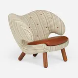Pelican chair by Finn Juhl, Maharam fabric and leather upholstery, walnut, sold Sep 2024