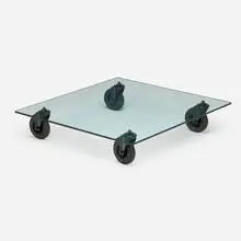 Coffee table on wheels by Gae Aulenti, 1980, glass, enameled steel, rubber, sold Sep 2024